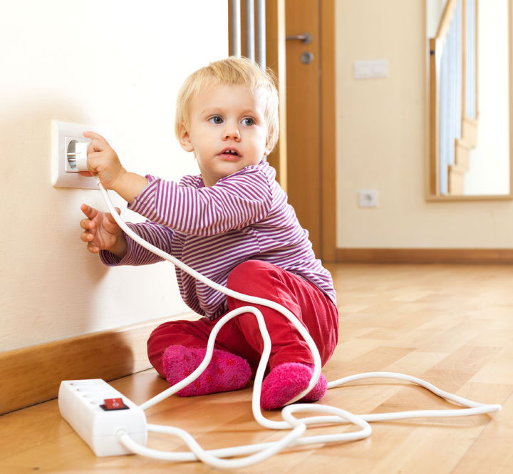 toddle playing with outlet